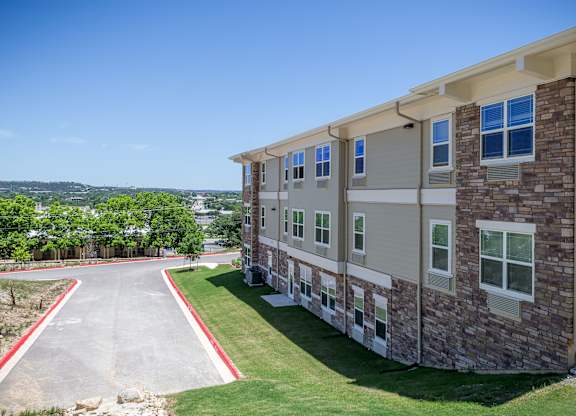 A building with a red border around the driveway.