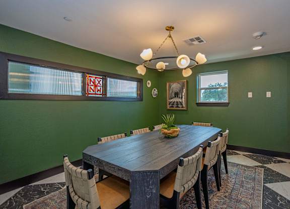 A dining room with a wooden table and chairs.