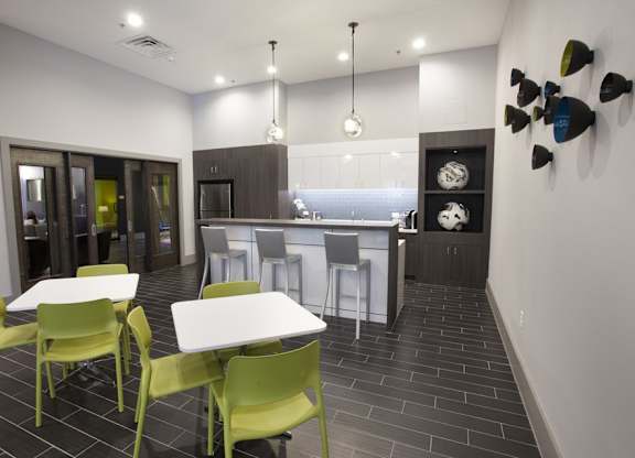 A modern kitchen with a dining table and chairs.
