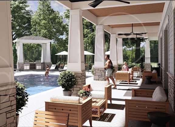 A pool area with a woman walking and several lounge chairs.