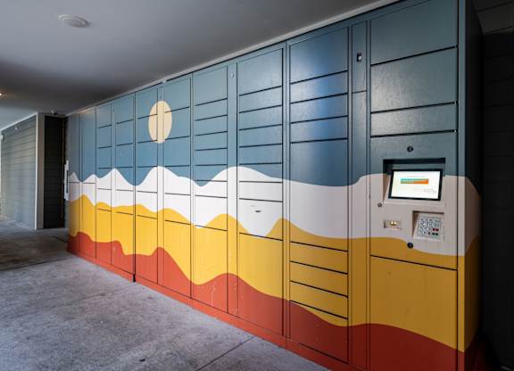A wall with a mountain design and a sun.