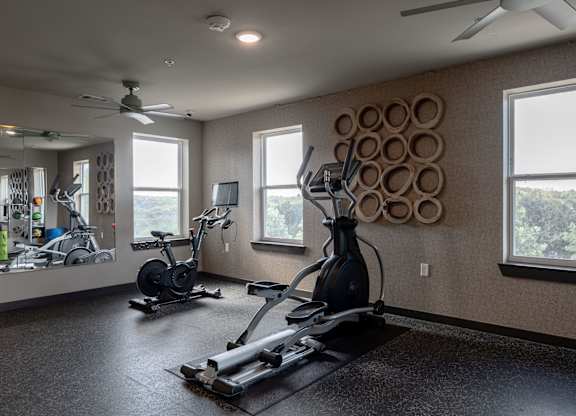 A spacious home gym with a variety of exercise equipment.