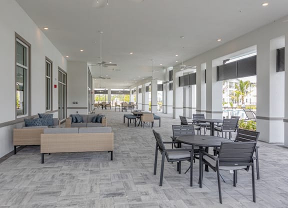 A spacious room with a long table and chairs.