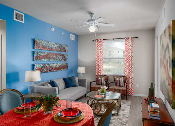 A living room with a dining table set for two.