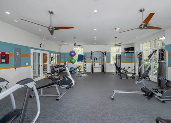 A gym with a variety of exercise equipment.