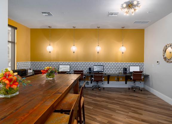A conference room with a long table and chairs.
