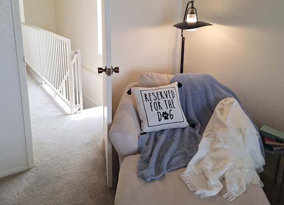 A small bed with a pillow that says "Reserved for D&B" on it.