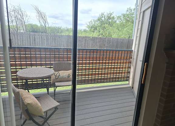 A patio with a table and two chairs.