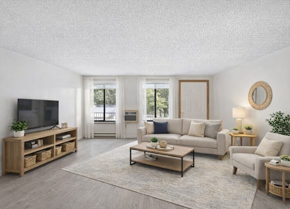 A living room with a white couch, a wooden coffee table, and a flat-screen TV.