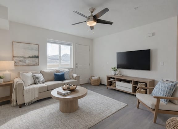 A living room with a couch, a coffee table, and a television.