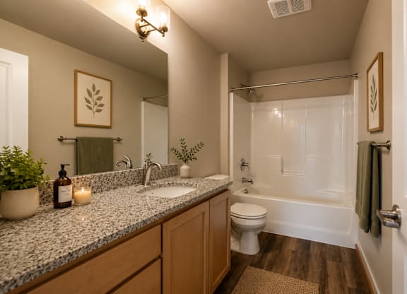 A bathroom with a toilet, sink, and bathtub.
