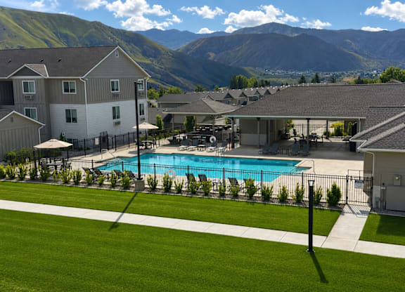 A swimming pool in a backyard with a mountain in the background.