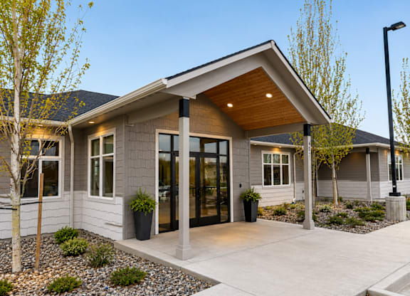 A modern house with a grey exterior and a wooden roof.