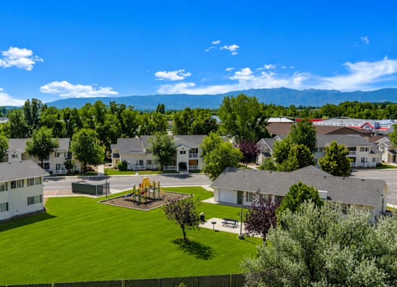 A large white building with a green lawn in front of it.