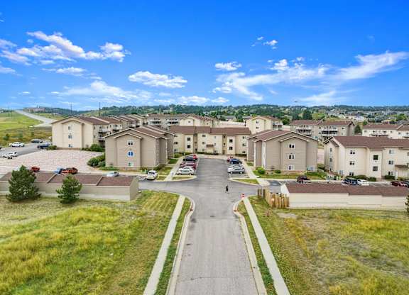 A residential area with houses and cars.