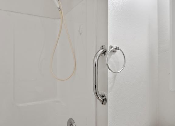A white door with a silver handle and a white cord hanging from it.