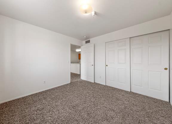 A room with white walls and a carpeted floor.