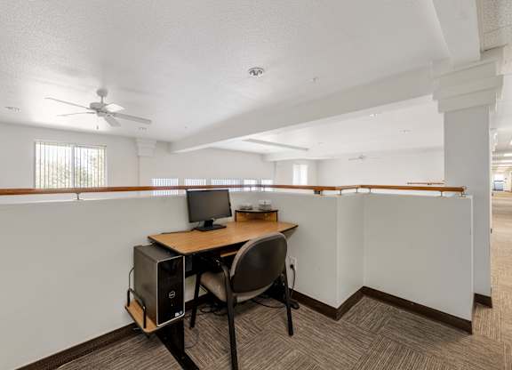 A room with a desk and a computer.