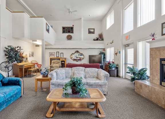 A living room with a blue couch and a wooden coffee table.