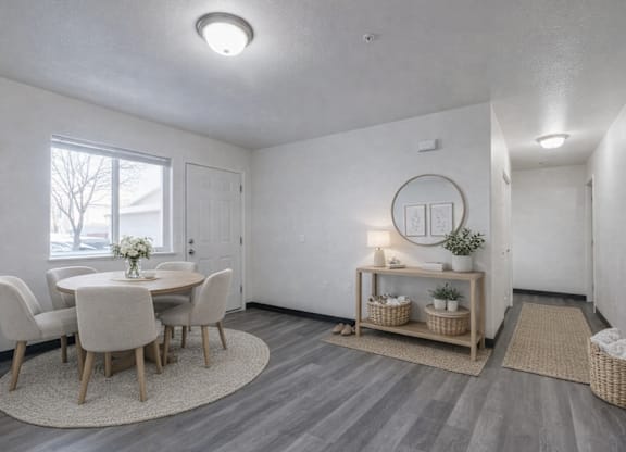 A dining room with a round table and chairs.
