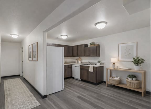 A modern kitchen with a white refrigerator and wooden cabinets.