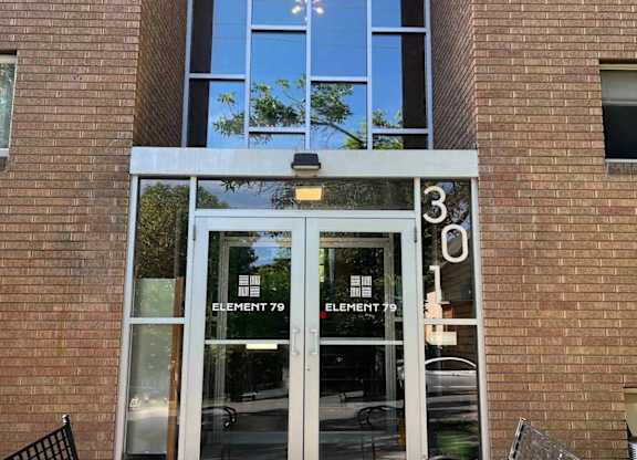 The front of a building with a glass door and windows.