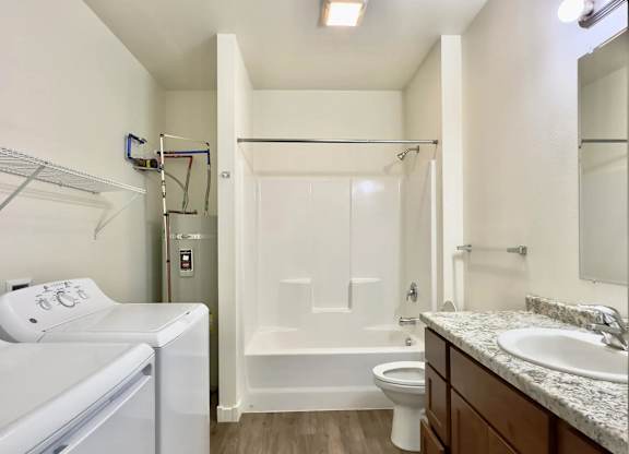 A small bathroom with a washer and dryer built in.