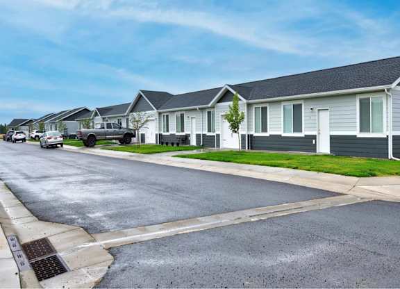 A street view of a residential area with houses on both sides.