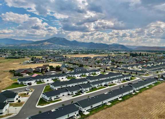 A suburban neighborhood with houses and a mountain in the background.