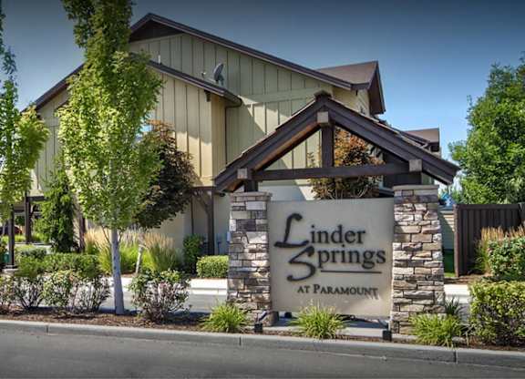 A building with a sign that says Linder Springs at Paramount.