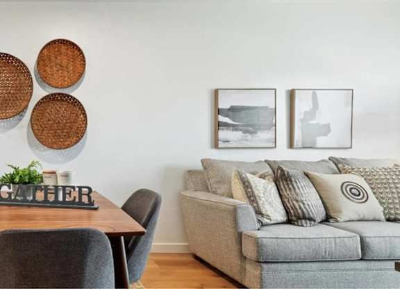 A modern dining room with a wooden table and chairs.