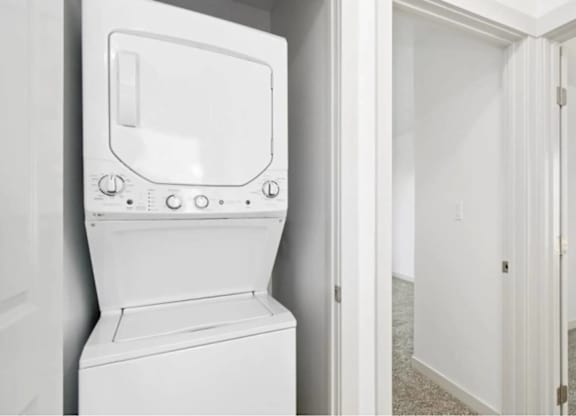 A white toilet with a white tank and a white door.