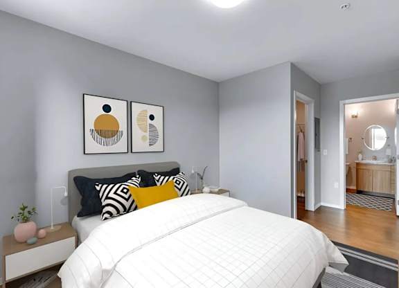 A bedroom with a large bed and two artworks on the wall.