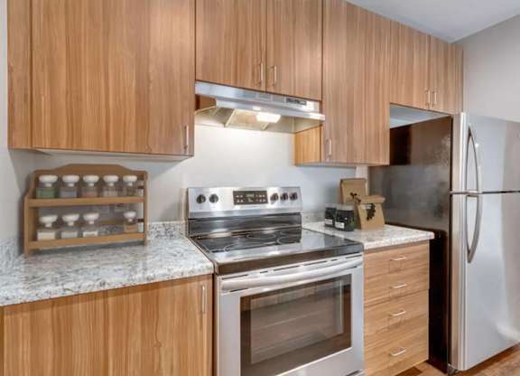 A kitchen with wooden cabinets and stainless steel appliances.