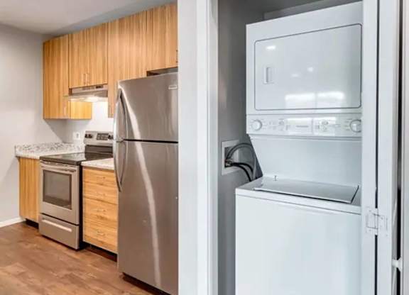 A white refrigerator is open in a kitchen.
