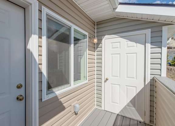 A small white door with a window above it.