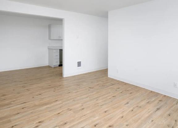 A room with a wooden floor and white walls.