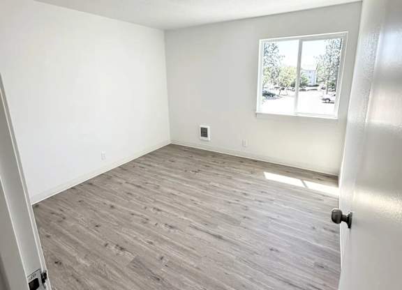 A room with a window and a door.