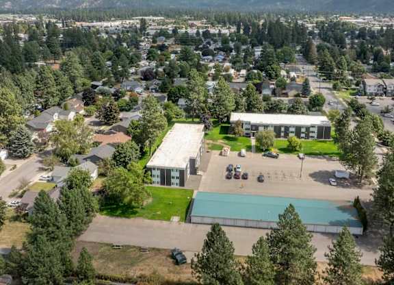 A small town with a large building in the center and a mountain in the background.