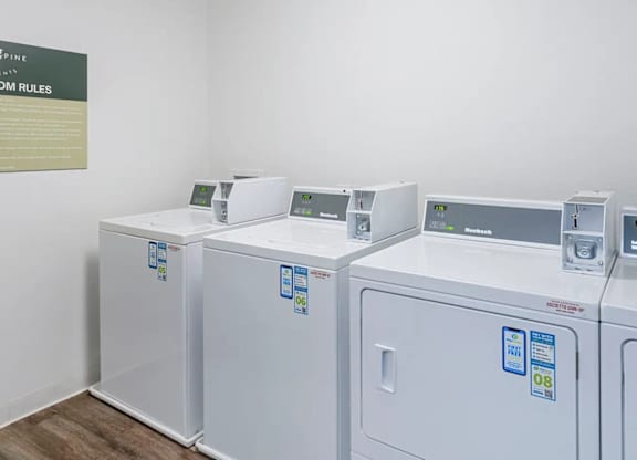 A laundromat with a sign that says "Expine Rules".