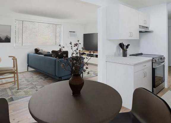 A living room with a blue couch and a brown table.