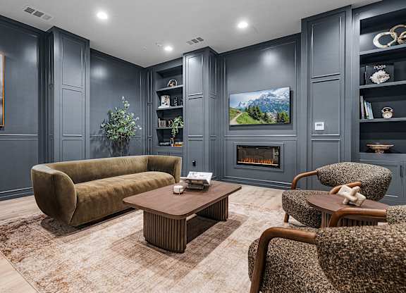 A living room with a fireplace and a painting on the wall.