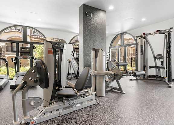 A gym with a variety of equipment including a leg press machine.
