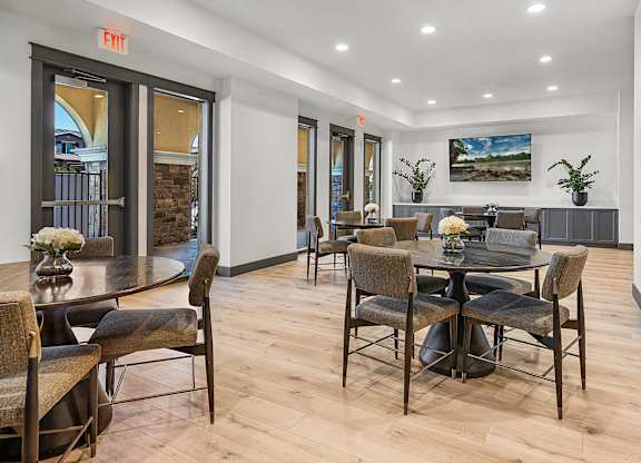 A dining room with a table and chairs.