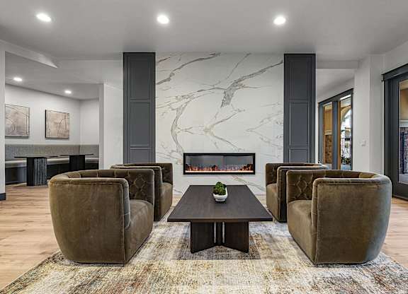 A living room with a fireplace and a rug.