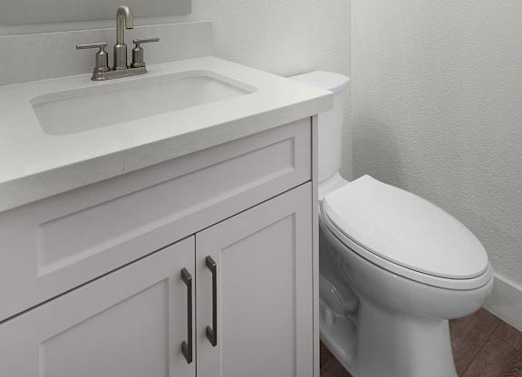 a bathroom with a sink and a toilet and a mirror