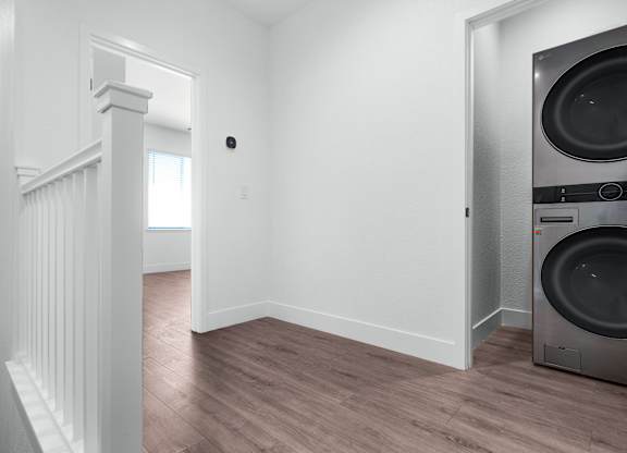 an empty laundry room with a washer and dryer