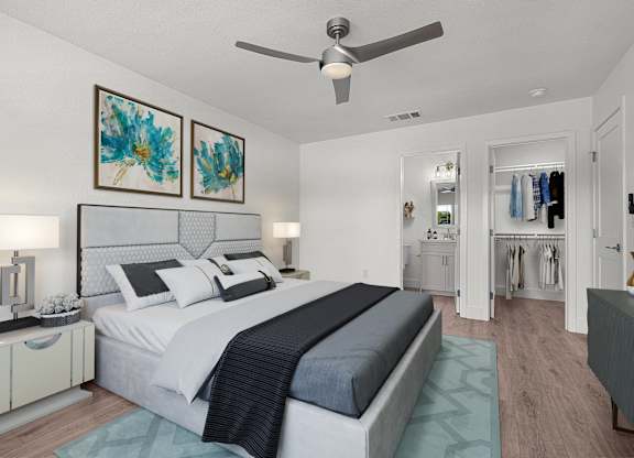 a bedroom with a bed and a ceiling fan