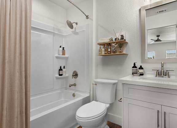 a bathroom with a toilet and a tub and a sink