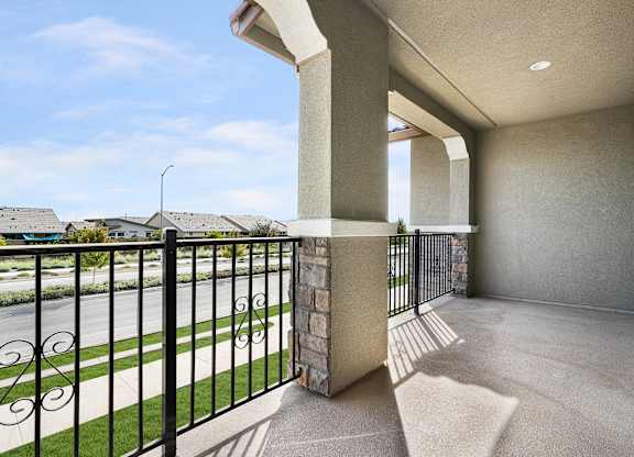 a balcony with a view of a street and a house